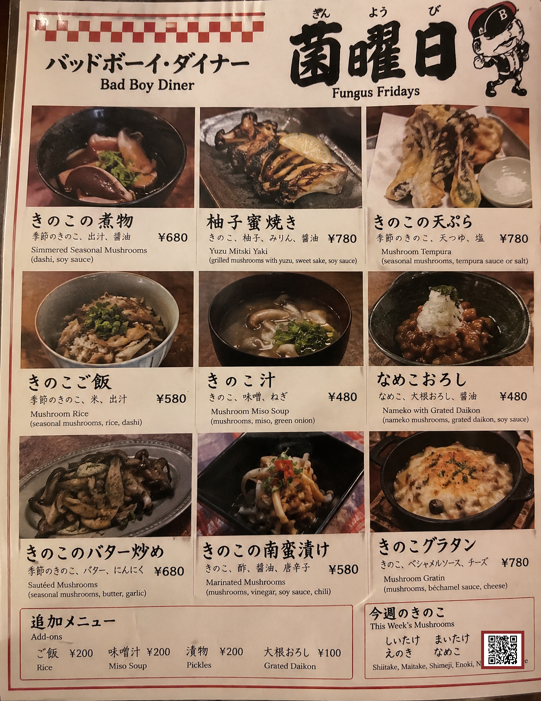 Bad Boy Diner 菌曜日 Kinyoubi -- Japanese Fungus Fridays menu, priced in yen: Kinoko no Nimono / Simmered Seasonal Mushrooms (dashi, soy sauce) &yen;680, Yuzu Mitski Yaki (grilled mushrooms, yuzu, sweet sake, soy sauce) &yen;780, Kinoko no Tenpura / Mushroom Tempura (seasonal mushrooms, tempura sauce or salt) &yen;780, Kinoko Gohan / Mushroom Rice (seasonal mushrooms, rice, dashi) &yen;580, Kinoko Jiru / Mushroom Miso Soup (mushrooms, miso, green onion) &yen;480, Nameko Oroshi / Nameko with Grated Daikon (nameko mushrooms, grated daikon, soy sauce) &yen;480, Kinoko no Bataa Itame / Sauteed Mushrooms (seasonal mushrooms, butter, garlic) &yen;680, Kinoko no Nanbanzuke / Marinated Mushrooms (mushrooms, vinegar, soy sauce, chili) &yen;580, Kinoko Guratan / Mushroom Gratin (mushrooms, bechamel sauce, cheese) &yen;780. Add-ons: Rice &yen;200, Miso Soup &yen;200, Pickles &yen;200, Grated Daikon &yen;100. This Week's Mushrooms (rotating, informational): Shiitake, Maitake, Shimeji, Enoki, Nameko, Hiratake. QR code links to this page.